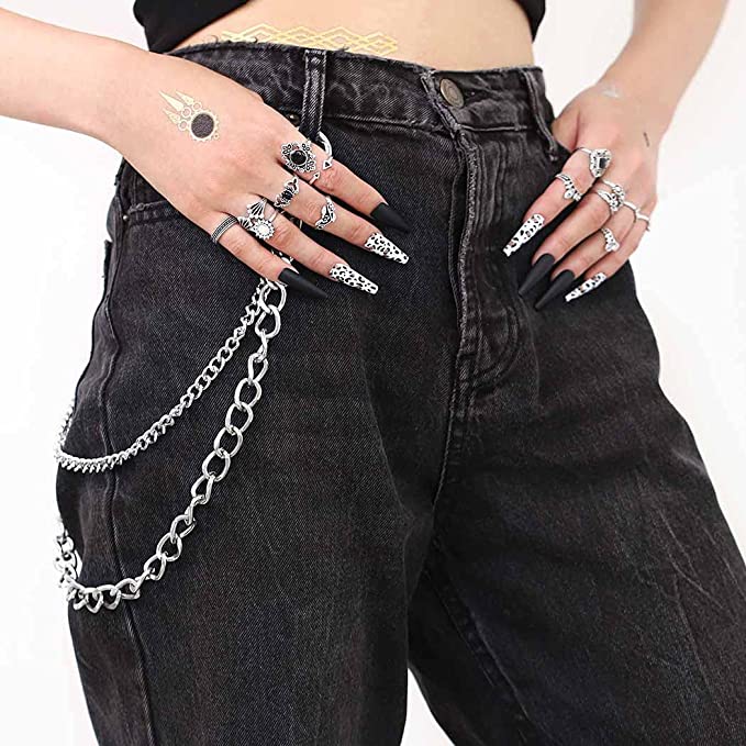 woman wearing black jeans with three piece keychain