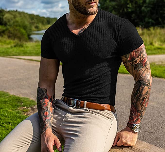 men with tattos sitting tight black tshirt