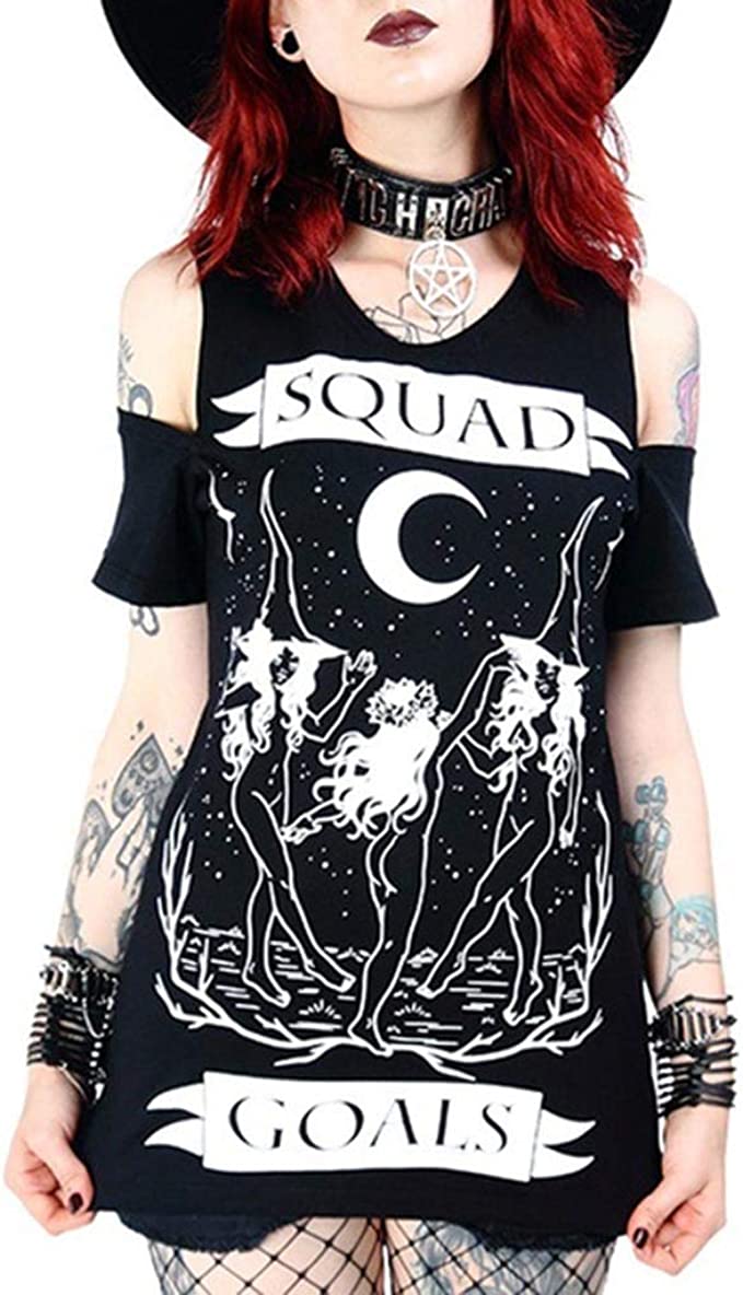 woman with red hair and tatoos wearing black tshirt with witch dance scene